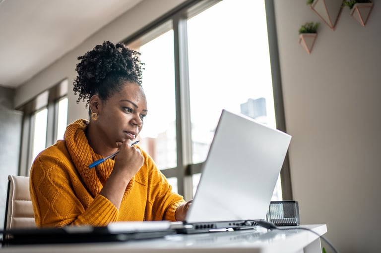 Black woman working from home office at a laptop