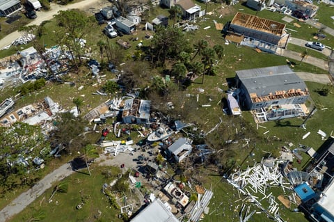 Severely damaged houses in a residential area after a hurricane