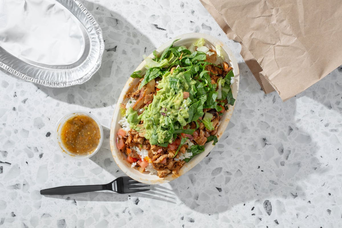 A top down view of a fast food restaurant burrito bowl.