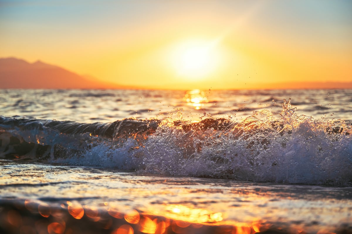 Beautiful sunrise over the Aegean sea with sand beach