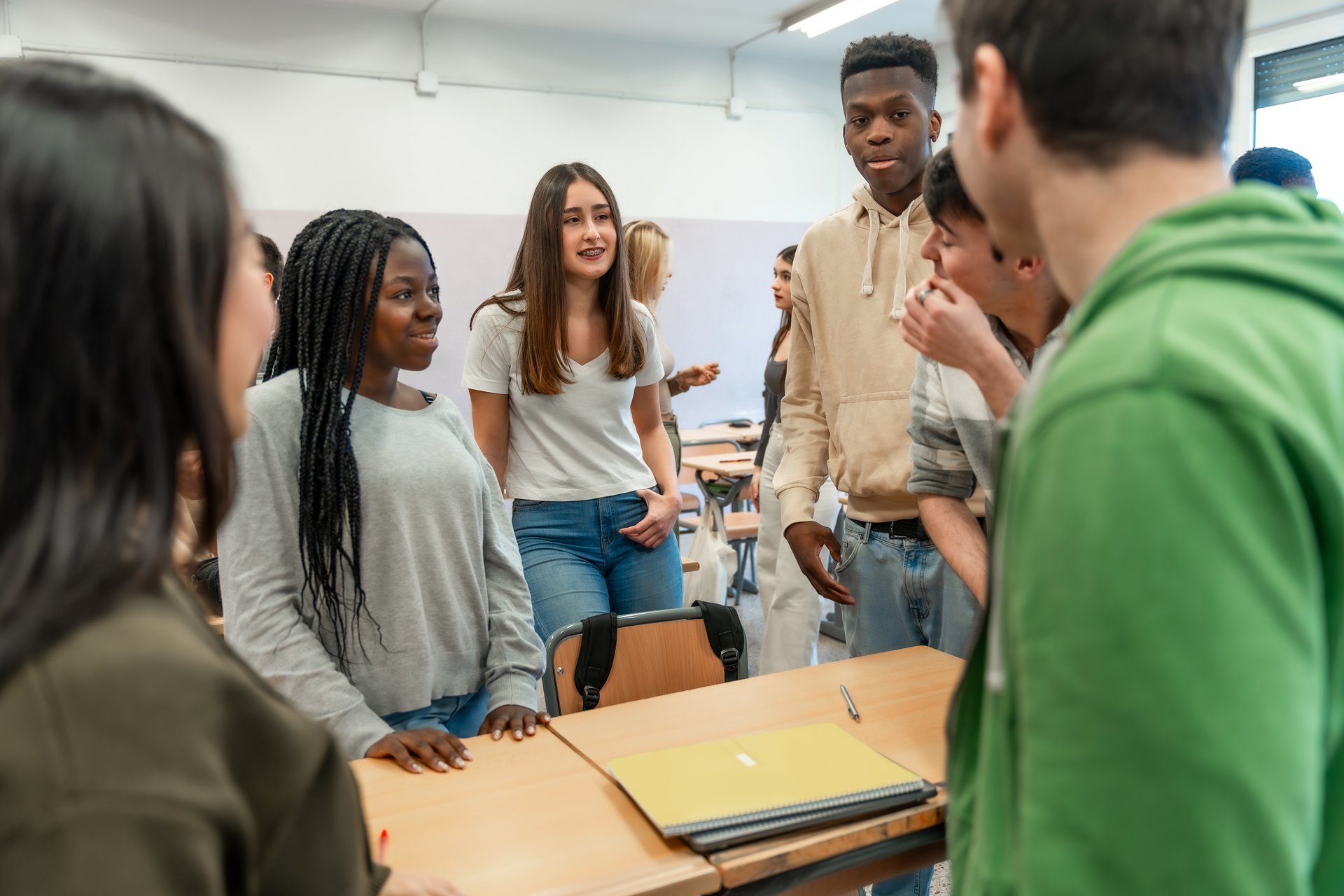 Diverse group of high school students collaborating and supporting each other