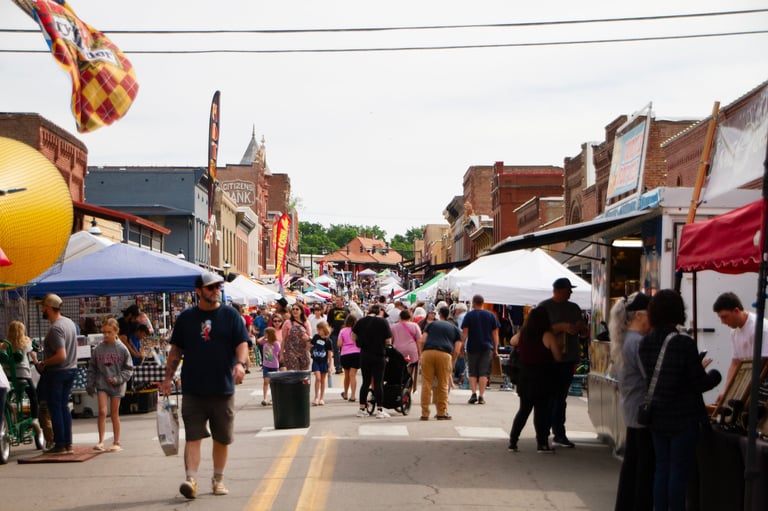 Small town community festival with local vendors and street fair atmosphere