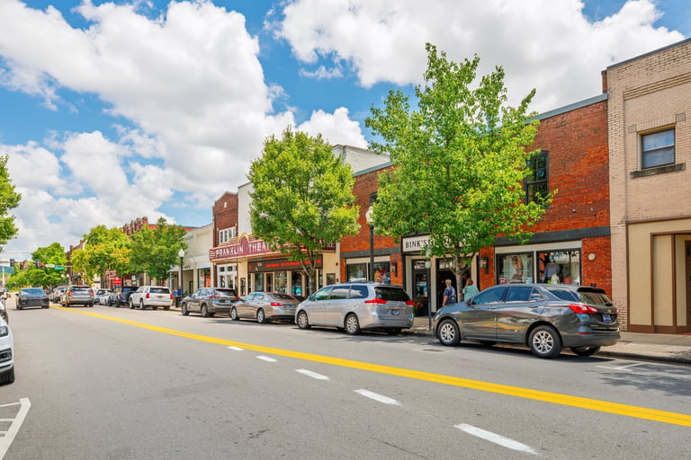 Historic Main Street in a small Southern town, representing why people who leave Florence often come back.