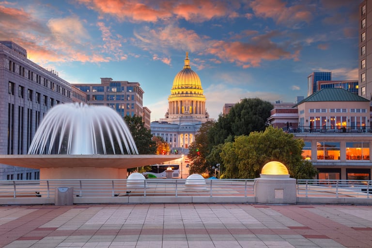 Madison Wisconsin Capitol building illuminated at sunset with fountain